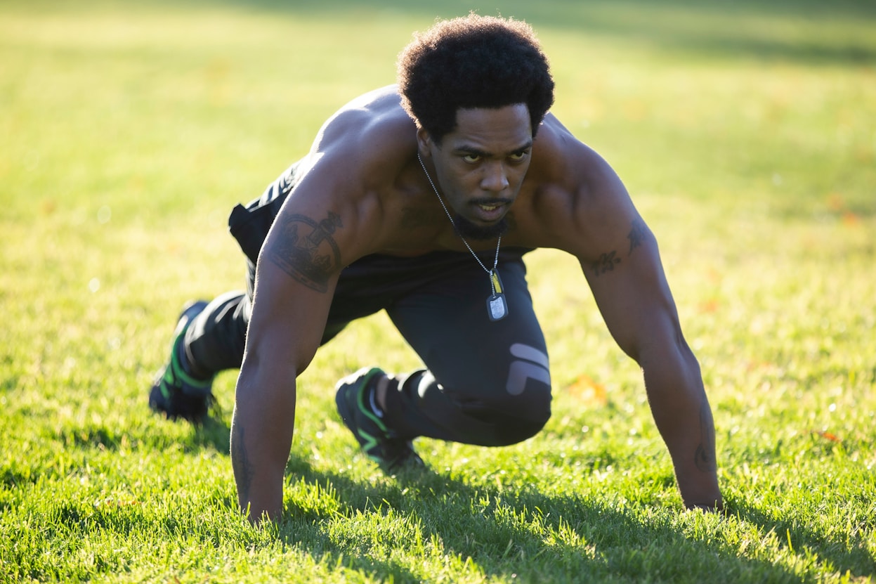 Man doing push-ups on grass